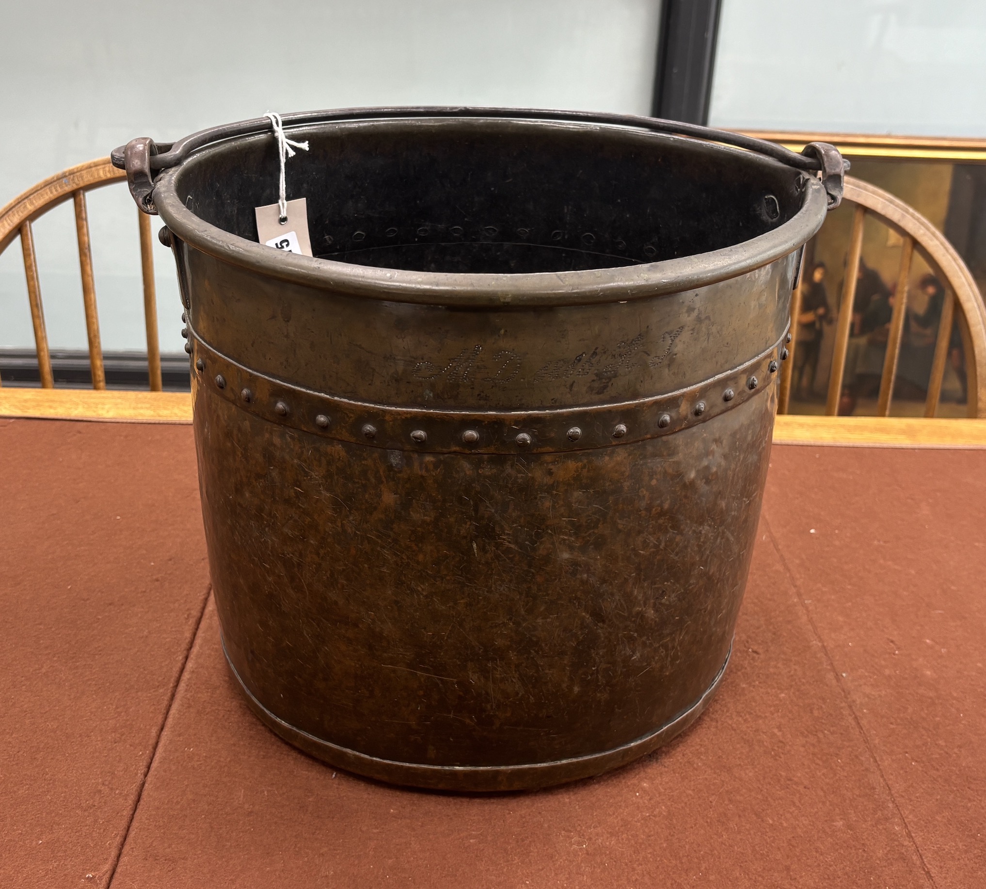 A late Victorian Arts and Crafts hammered copper coal bucket with iron swing handle, diameter 34cm, height 31cm.